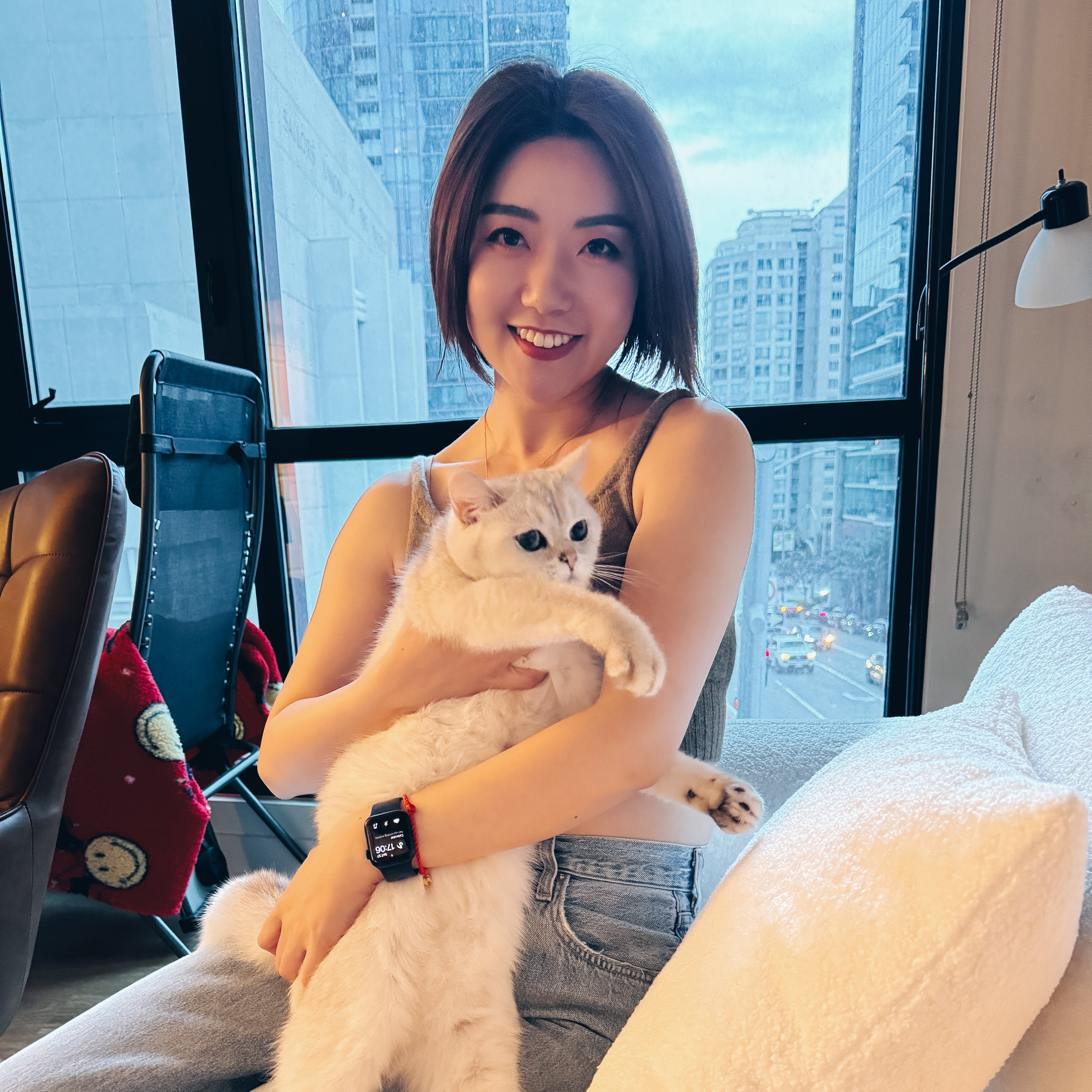 Vivian, founder of Pawsy Pals, holding her cat Pinot — the inspiration behind custom pet portrait phone accessories