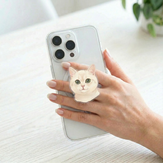 Phone case with a cat design held by a hand on a light surface.
